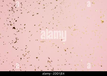 Golden sparkles on a pink paper background. Template for card, invitation. Stock Photo