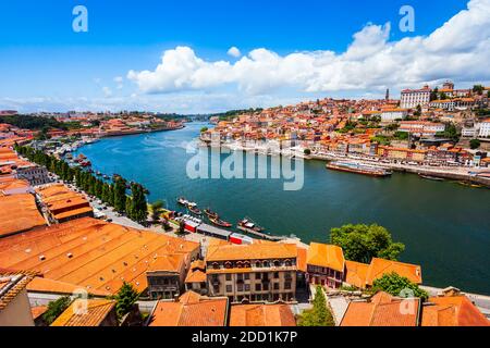 Douro river and local houses with orange roofs in Porto city aerial panoramic view. Porto is the second largest city in Portugal. Stock Photo