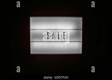 Sale word on Illuminated lightbox in dark Stock Photo