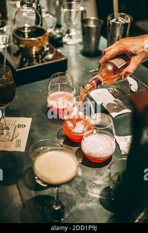 Bartender making an alcoholic cocktail, a summer cocktail in the bar Stock Photo