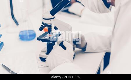 close up. image of a scientist looking through a microscope . Stock Photo