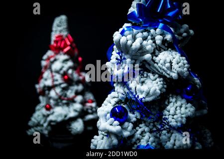 Decorated snow Christmas trees isolated on black background Stock Photo