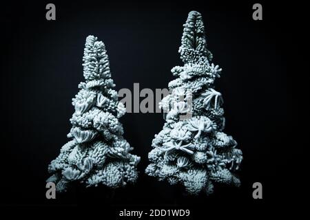 Decorated snow Christmas trees isolated on black background Stock Photo
