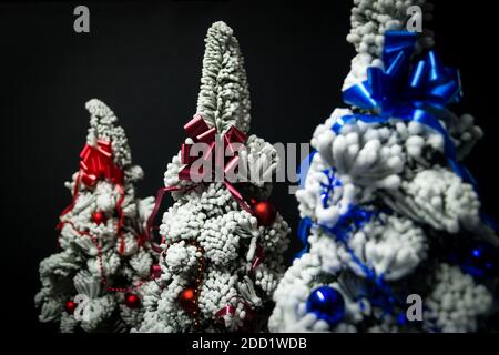 Decorated snow Christmas trees isolated on black background Stock Photo