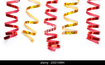 Red and gold serpentines isolated over white background. Top view Stock Photo