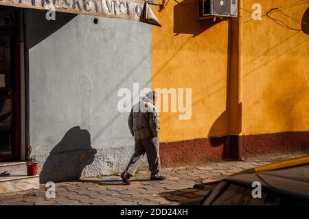 A man walking in one of the main street in Tirana Stock Photo