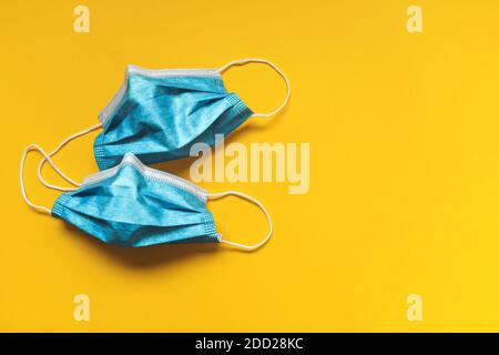 Two masks preventive against virus on yellow background Stock Photo