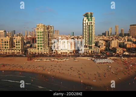 Aerial drone image of Tel Aviv, Israel waterfront at golden hour, featuring the Banana Beach and Royal Beach Hotel. Stock Photo