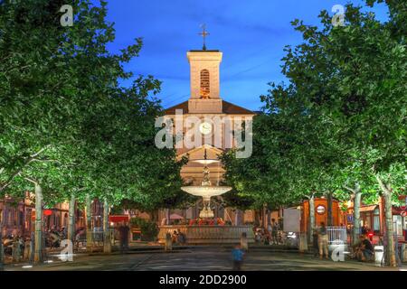 Night scene in Place de Marche, Carouge, Geneva, Switzerland with the Church of Sainte-Croix overlooking the square. Stock Photo