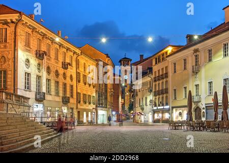 Night street scene in Piazza Collegiata with the tower of the Town Hall (Palazzo Civico) in Bellinzona, Switzerland Stock Photo
