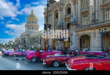 Havana, Cuba 16 February, 2020 - Vintage colorful taxis waiting for tourists close to National Capitol Building (El Capitolio) on Paseo del Prado street in front of Gran Havana theater Stock Photo