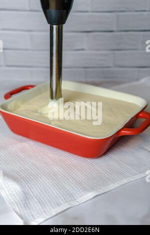 Blending the batter for cottage cheese casserole Stock Photo