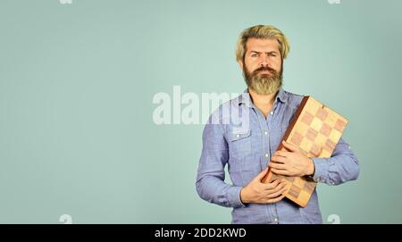 bearded man hold chess board. intelligence quotient. human brain working. brainstorming concept. play chess tournament. copy space. Intelligence level measurement. level up your iq. copy space. Stock Photo