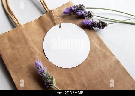 Blank White Circle Gift Tag Mock Up - On Brown Paper Bag Stock Photo