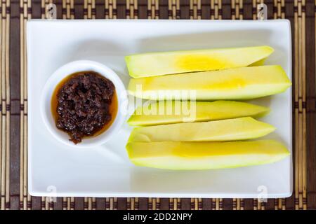 Slices of green mangos with traditional Filipino fermented shrimp paste Stock Photo