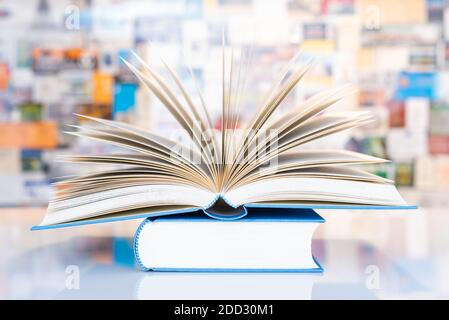 Open book on table in front of colorful soft background Stock Photo