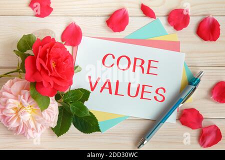 Red roses and the inscription Core Values on a white wooden background for card design. Stock Photo