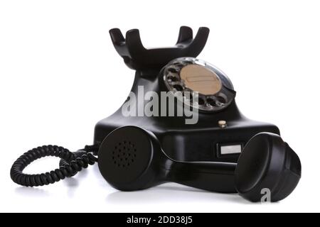 Vintage telephone with receiver taken off in focus, isolated on white background Stock Photo