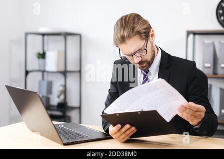 Focused man working with documents at office Stock Photo