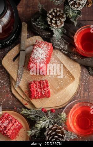 Strawberry piece of cake and red fruit tea, with winter decorations Stock Photo