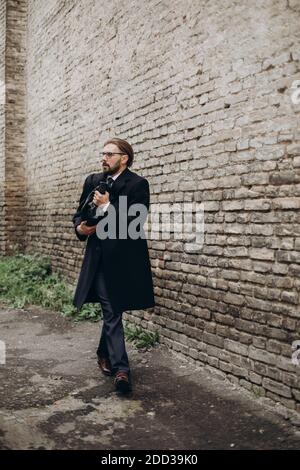 Scared man embracing bag while walking outdoors Stock Photo