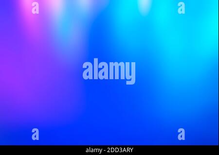 Iridescent holographic abstract bright neon colors background. Blurred colorful multicolored backdrop from lights Stock Photo