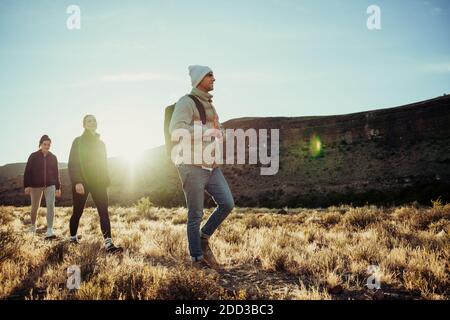 Group of teenagers walking through mountain setting enjoying fresh air Stock Photo