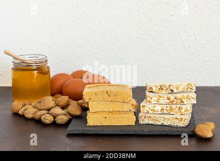 Turron, typical Christmas sweet in Spain. Almond nougat on black stone plate Stock Photo