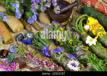 Still life with herbal scrolls, candles, utensils on witch table. Esoteric, occult and mystic concept, alternative medicine background with natural he Stock Photo