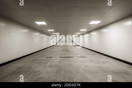 The dark pedestrian tunnel is empty and empty. Stock Photo