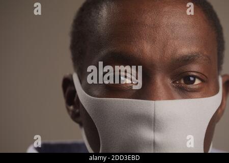 Close-up of African man in protective mask looking at camera during pandemic Stock Photo