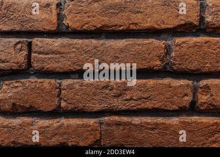 brick wall red dark black seams background for construction. Stock Photo