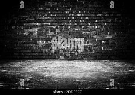 Old dark room with brick wall and concrete floor - as background Stock Photo