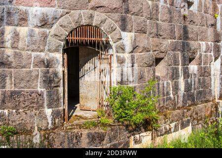 Old rusty Iron gate in a fortified wall Stock Photo