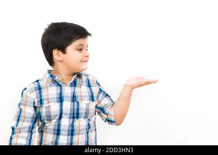 Cute Asian boy looking at empty open palm (hand) Stock Photo