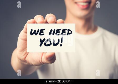 WE NEED YOU! message on the card shown by a man, vintage tone effect Stock Photo