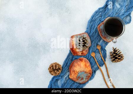 Coffee cup and resin art plates on blue background. Flat lay, top view Stock Photo