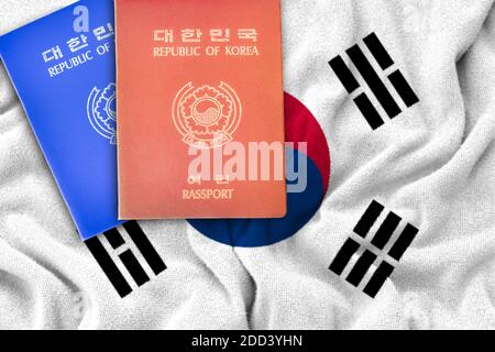 South Korean passport on the fabric flag of republic korea. Stock Photo