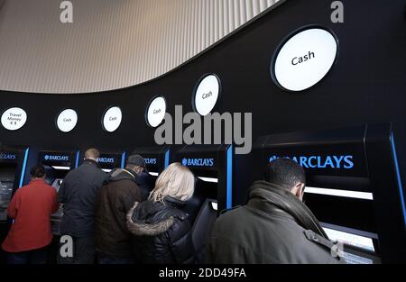 GREAT BRITAIN / London /Customers use a cashpoint machine at a Barclays Bank branch in London . People withdrawaL cash at ATM . Stock Photo