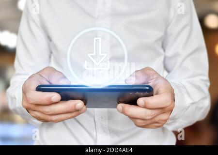 Businessman hand using mobile phone with web download icon on virtual touchscreen interface. Stock Photo