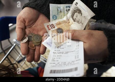 GREAT BRITAIN / England /Sterling pound notes and coins in Human Hand.man counting coins and bank notes for saving. money saving Stock Photo