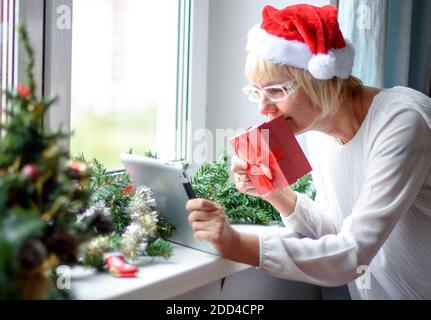 Smiling woman using mobile tablet for video call friends and parents Stock Photo