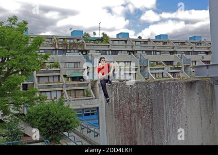 Free runner practicing parkour at housing estate in London , United Kingdom Stock Photo