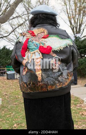 Devout Roman Catholic woman in a homemade jacket depicting Saint Michael, the archangel. At the Vatican Pavilion site in Flushing Meadows Corona Park Stock Photo