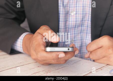 man in suit using smart phone on office desk  Stock Photo