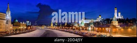 Panorama cityscape of Moscow, Russia, in the winter at blue hour with the frozen Moskva River, the medieval Moscow Kremlin on the right and the modern Stock Photo