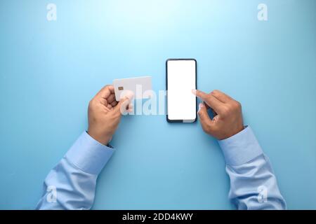 Man hand holding credit card and using smart phone shopping online  Stock Photo
