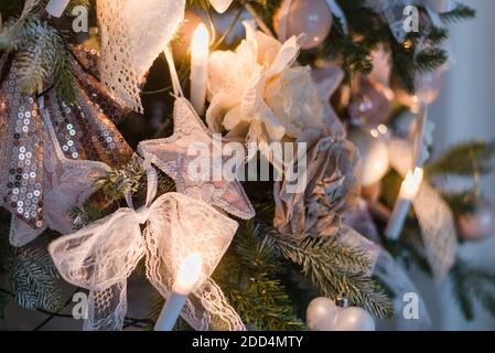 Christmas ornaments are decorations usually made of glass, metal, wood or ceramics that used to festoon a tree. Blurred gifts on background. Stock Photo