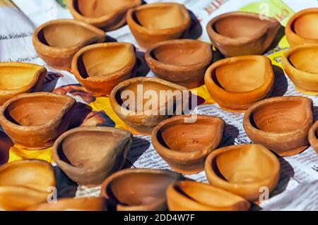 Earthen lamps/clay lamps being dried in sun before the festival of Diwali. Stock Photo