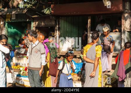 A crowd of people throng a roadside market on the Shillong-Guwahati highway, Meghalaya, India. Stock Photo